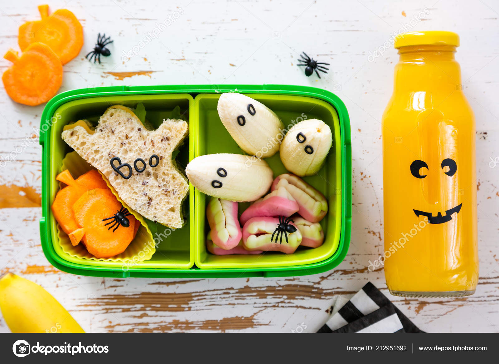 Halloween style school lunch box ghost sandwich, pumpkin carrots