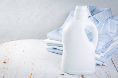 Kavram - katlanmış gömlek yığını, yıkama deterjan şişesi ile yıkama