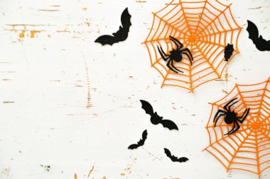 Cadılar Bayramı kavramı - örümcekler, yarasalar, parlak arka plan üzerinde web kağıt el sanatları