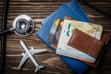 Medical tourism concept - passports, stethoscope, airplane, money clipart