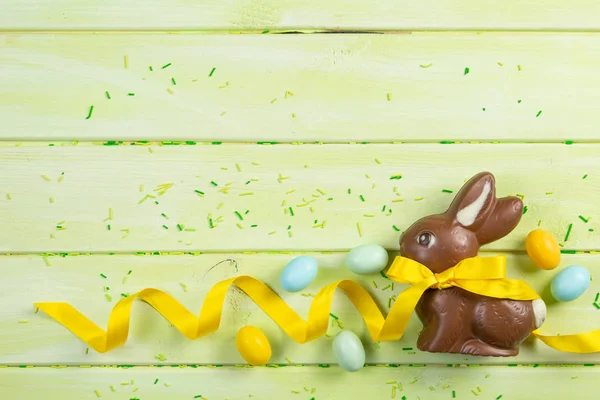 Fundo de Páscoa - coelho de chocolate com fita amarela — Fotografia de Stock