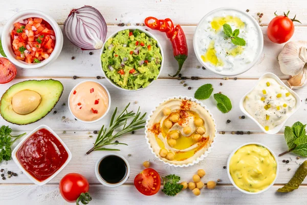 Selection of sauces in white bowls on white bowls — Stock Photo, Image