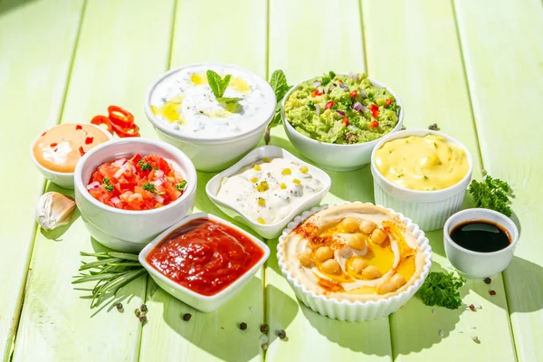 Selection of sauces in white bowls on white bowls — Stock Photo, Image