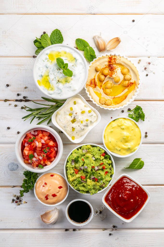 Selection of sauces in white bowls on white bowls