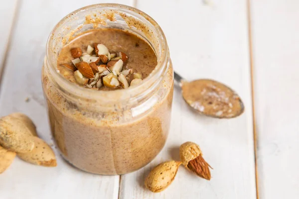 Almond butter in glass jar — Stock Photo, Image