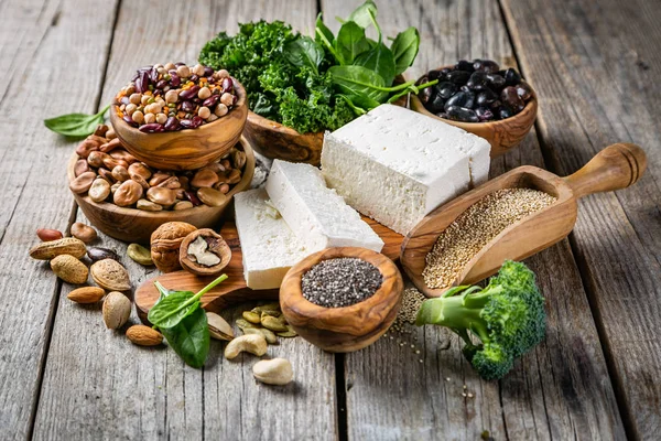 Selection of vegan plant protein sources - tofu, quinoa, spinach, broccoli, chia, nuts and seeds