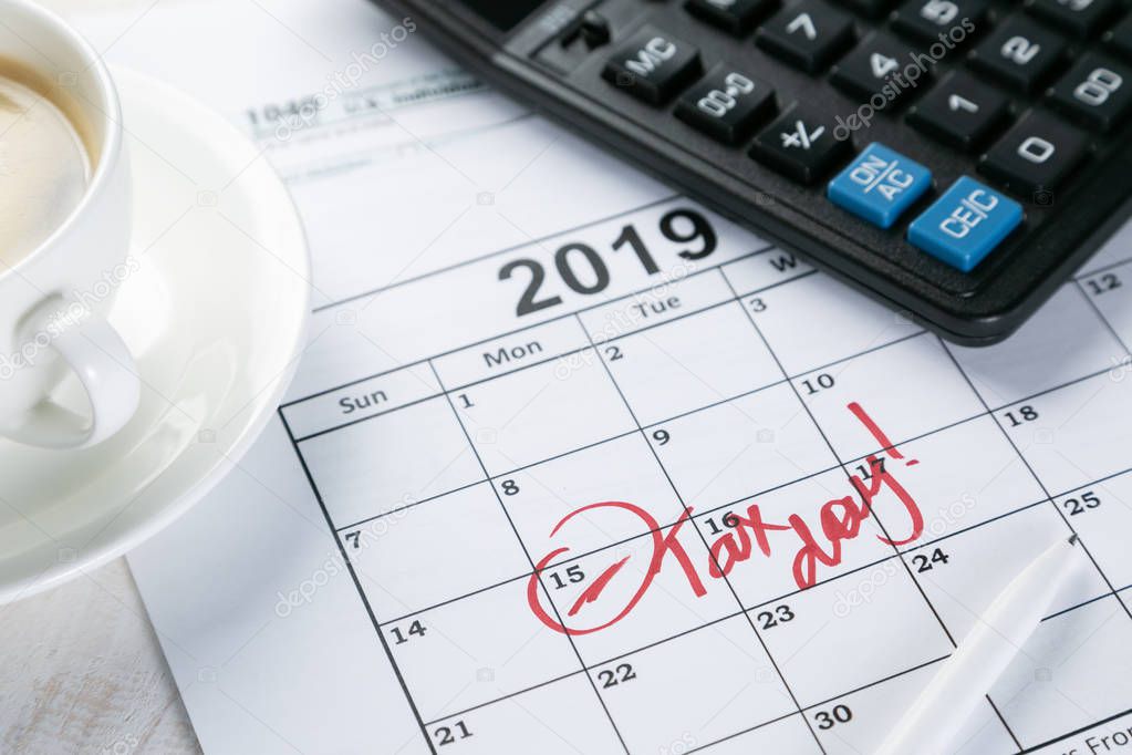Tax day concept - calculator, calendar, tax form