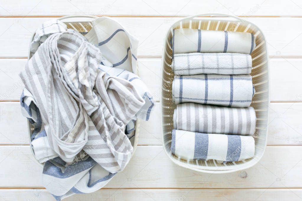 Marie Kondo tidying concept - folded kitchen linens in white basket