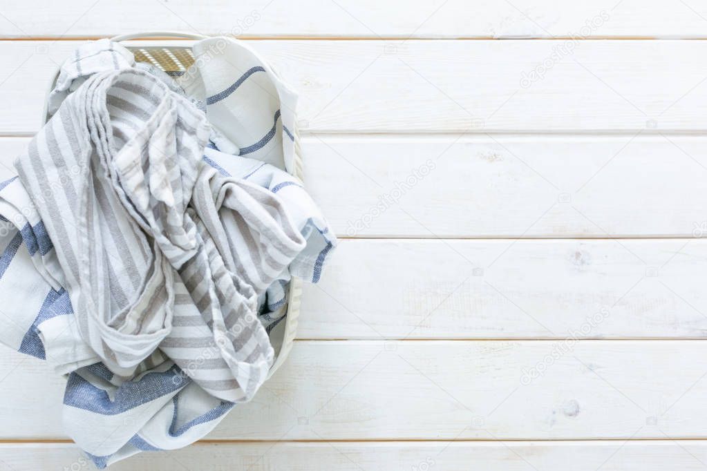 Marie Kondo tidying concept - folded kitchen linens in white basket