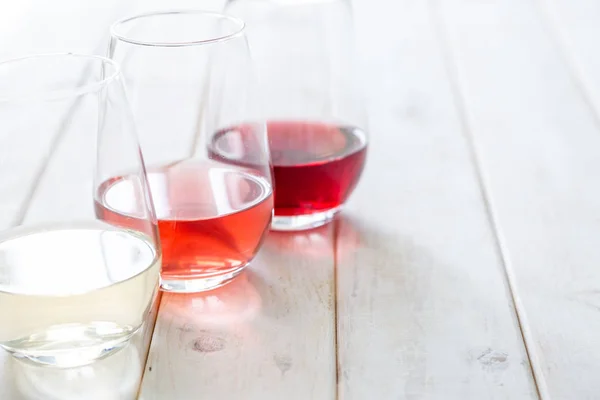 WIne tasting concept - red, rose and white wine in glasses — 스톡 사진