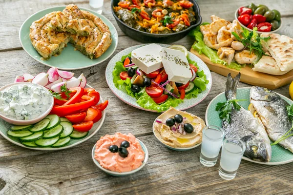 Selection of traditional greek food - salad, meze, pie, fish, tzatziki, dolma — Stock Photo, Image