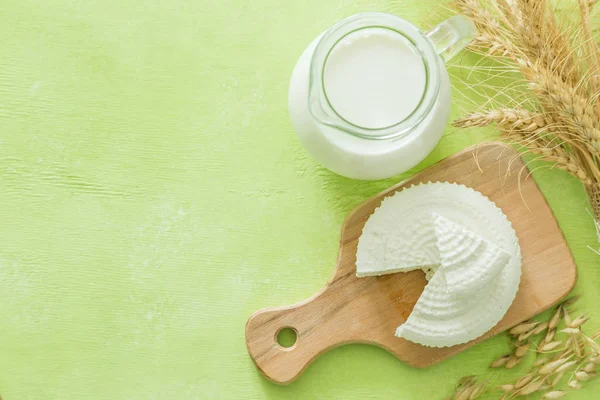 Conceito de Shavuot - produtos lácteos e trigo sobre fundo de madeira verde — Fotografia de Stock