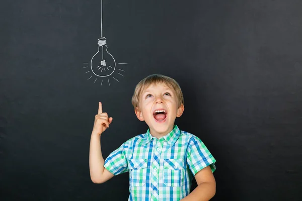 Back to schhol concept - funny boy in front of blackboard