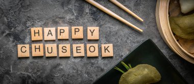 Chuseon day concept, korean thanksgiving day - songpyeon rice cakes on rustic background clipart