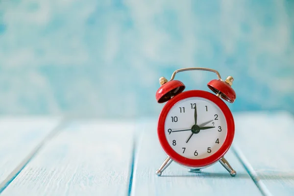 Autumn time change concept - red alarm clock on wood background — Stock Photo, Image