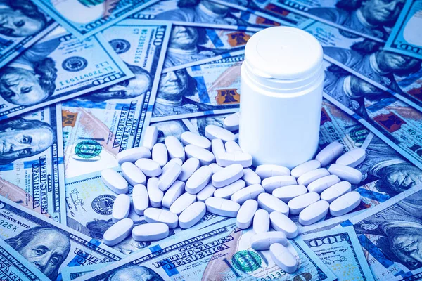用100美元钞票做背景的药丸 昂贵的医疗或医疗融资成本的概念 白色药瓶 有文字复制空间 — 图库照片