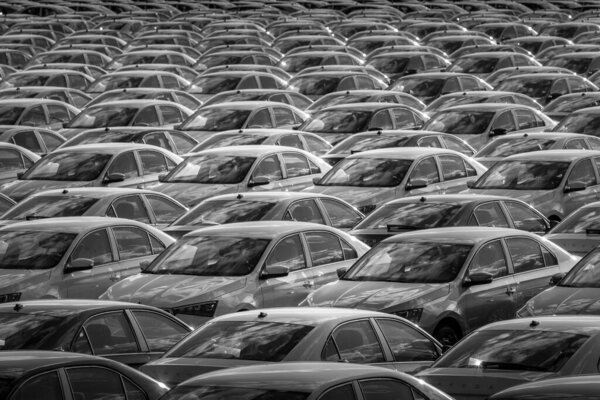 Volkswagen Group Rus, Russia, Kaluga - MAY 24, 2020: Rows of a new cars parked in a distribution center on a day in the spring, a car factory. Parking in the open air. Black and white photography.