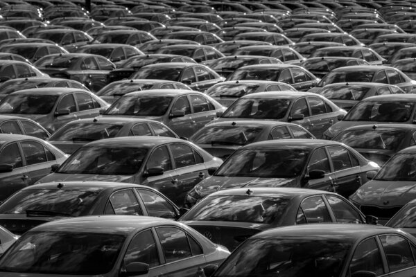 Volkswagen Group Rus, Russia, Kaluga - MAY 24, 2020: Rows of a new cars parked in a distribution center on a day in the spring, a car factory. Parking in the open air. Black and white photography.