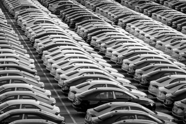 Volkswagen Group Rus, Russia, Kaluga - MAY 24, 2020: Rows of a new cars parked in a distribution center on a day in the spring, a car factory. Parking in the open air. Black and white photography.