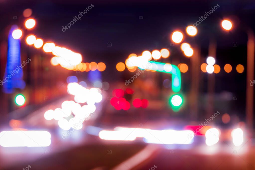 Traces of headlights from cars moving at night on the bridge, illuminated by lanterns. Abstract blured defocused city landscape with highway at dusk. 