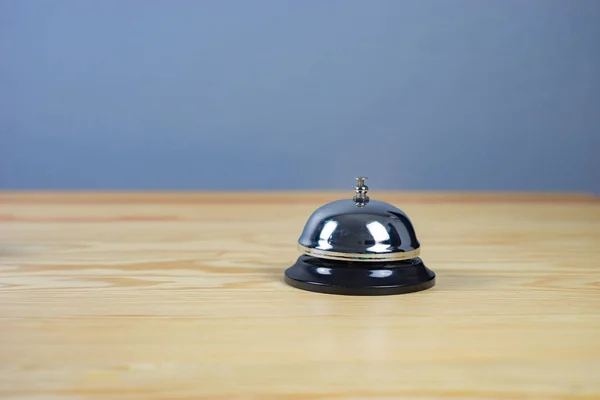 close up on silver service bell on wooden table