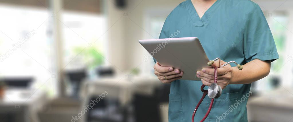 selective focus of male doctor using tablet in hospital