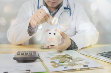 Kumbara tutarak ve hesap makinesi ile madeni para sayma doktor