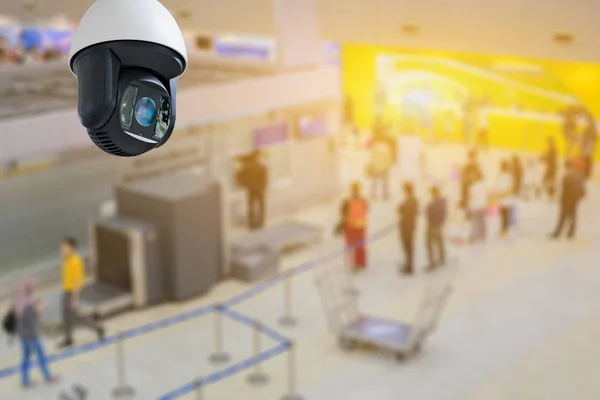 Security camera at checkpoint in airport with people at background