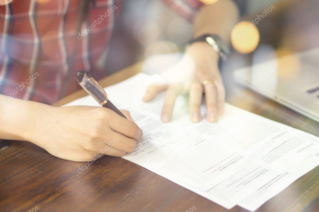 Businessman signing contract at table in office