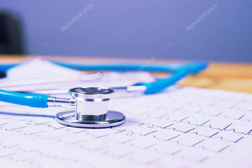 Stethoscope and  heart cardiogram on clipboard pad