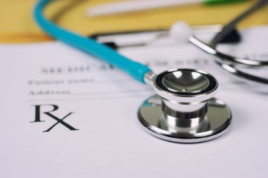 Masada reçeteli panosu olan stetoskop.