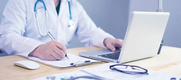 의사가 노트북을 테이블에서 클립보드에 — 스톡 사진
