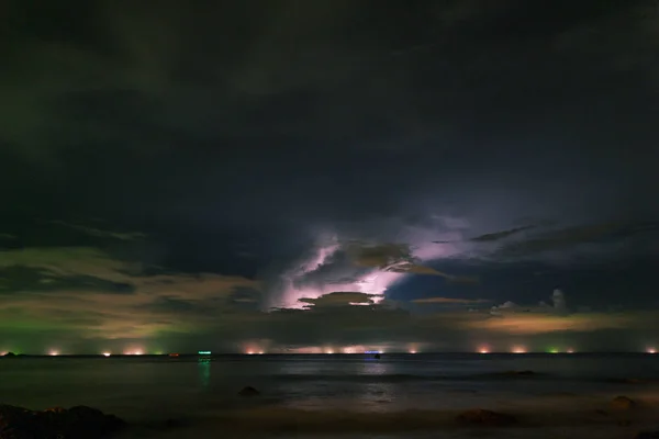 storm clouds in the sky over sea in night long exposure shot.