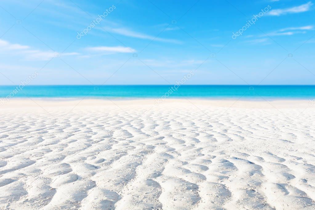 White sand curve or tropical sandy beach with blurry blue ocean and blue sky background image for nature background or summer background.