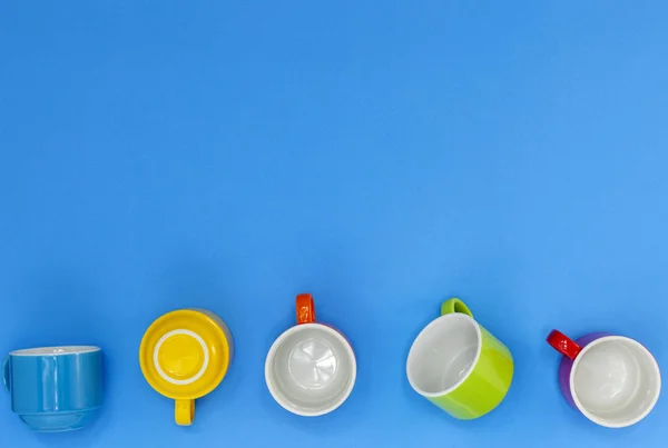 colorful coffee cups isolated on blue background.