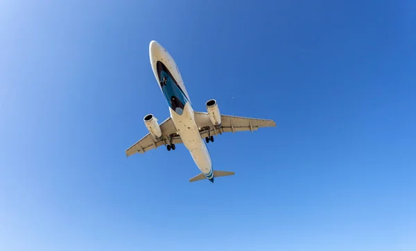 Passenger airplane landing clear blue sky and clouds background