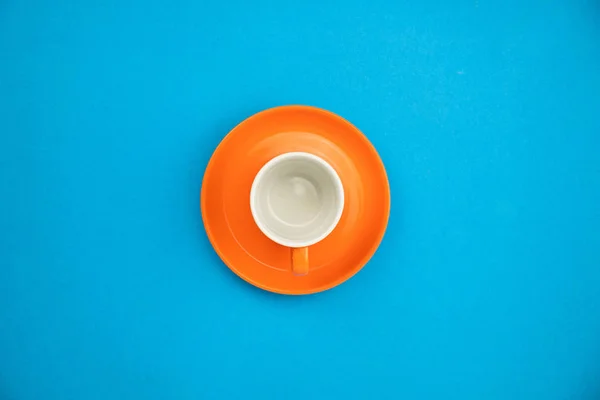 Colorful coffee cup on blue paper background