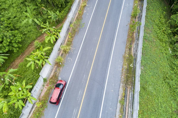 Aerial view Drone shot of red suv car on road