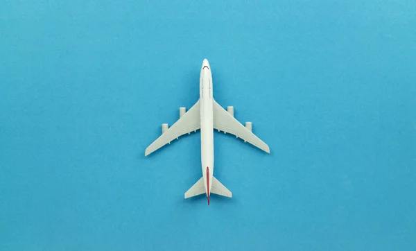 Top view airplane model on blue background