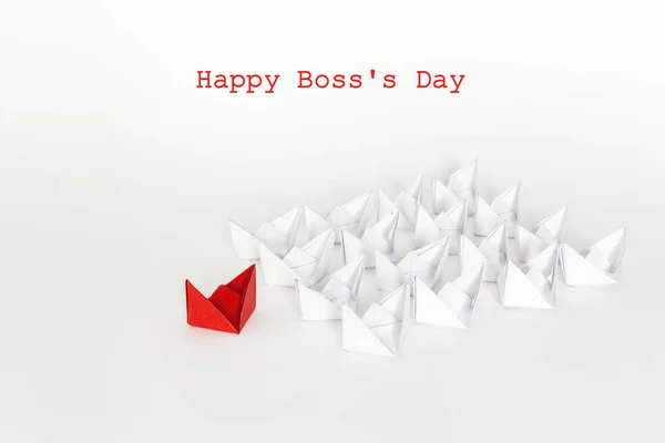 Boss day background with red paper ship leading white boats. Happy boss day concept. Leadership concept.