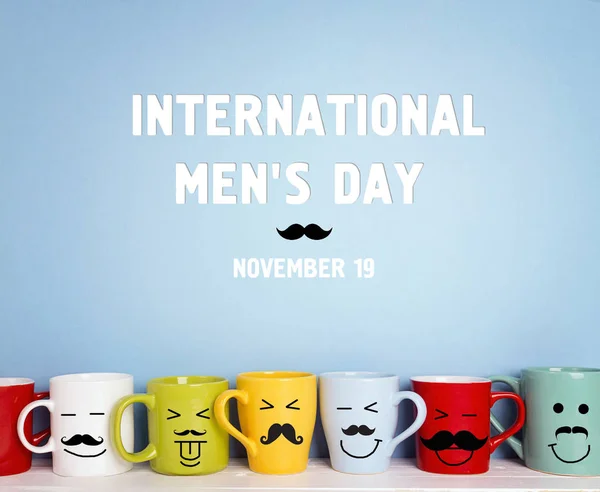 International men\'s day background with colorful mugs with a mustache on a blue background.