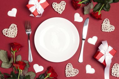 Festival tablo ayarını çatal bıçak takımı, gül çiçek ve hediye kutuları kırmızı masada. Kopyala alanı, düz yatıyordu, yukarıdan aşağıya kompozisyon. St Sevgililer günü arka plan. 