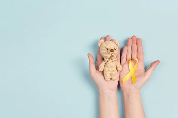 Flicka Händerna Hålla Barns Leksak Med Barndom Cancer Awareness Gult — Stockfoto