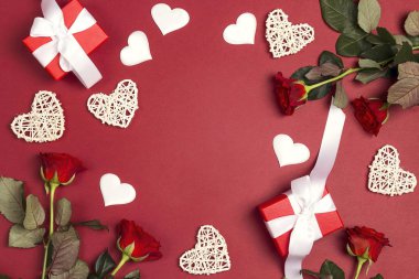 Romantik çerçeve hediyeler, gül çiçekler ve kırmızı zemin üzerine dekoratif kalpler. Metin, kompozisyon en iyi yer. St Sevgililer günü kavramı. 
