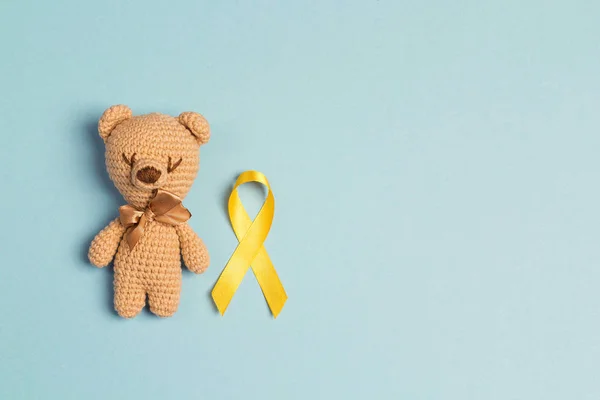 Children Toy Childhood Cancer Awareness Yellow Ribbon Blue Background Childhood — Stock Photo, Image