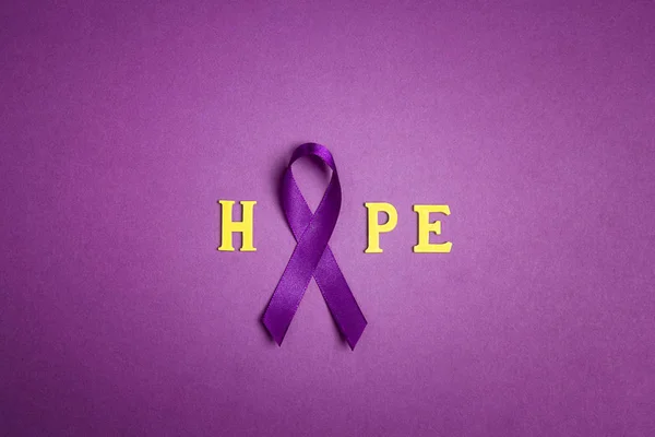 Purple epilepsy awareness ribbon with word hopr on a purple back