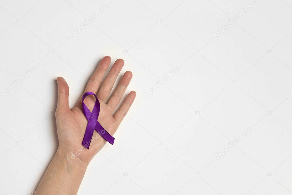 Hand holding Purple ribbons on a white background. World epileps