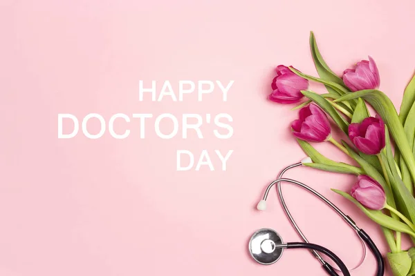 Dia do médico cartão de saudação com um monte de tulipas e estetoscópio — Fotografia de Stock