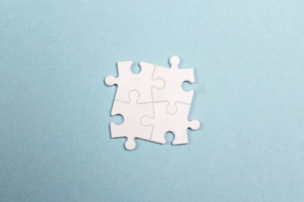 Four white puzzle pieces. — Stock Photo, Image