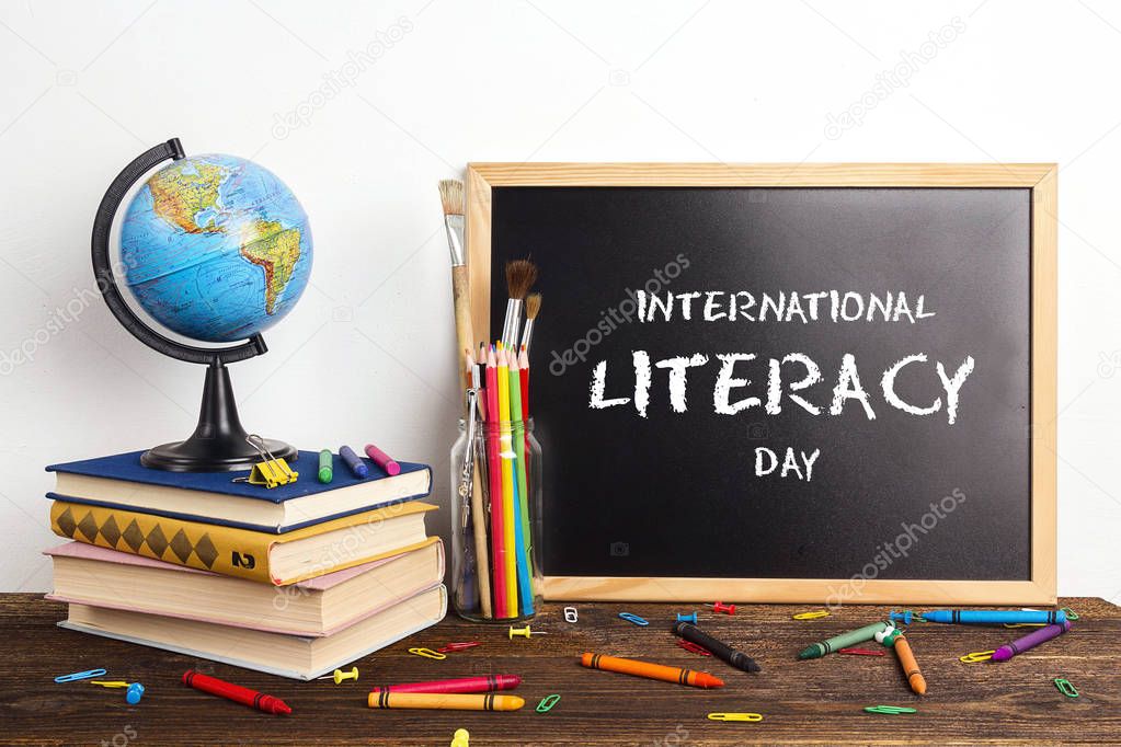 International Literacy Day. Chalkboard, a globe, a stack of book